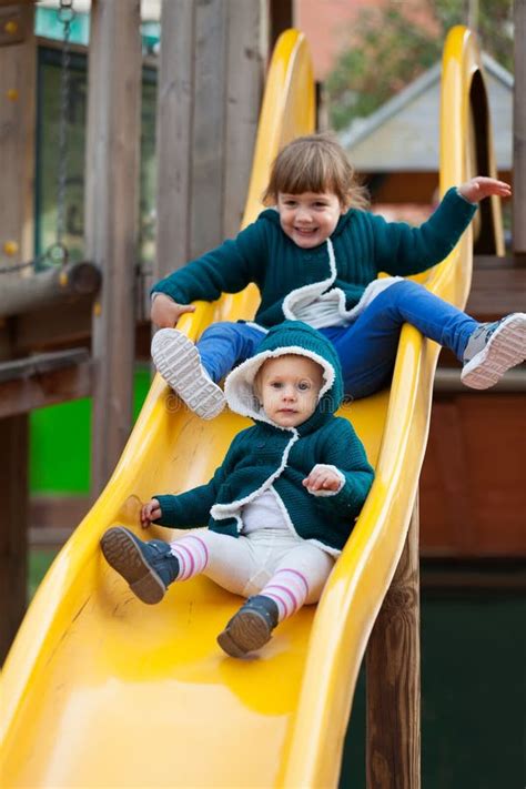 Kids laughing and having fun on a sliding board